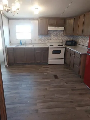 a kitchen with stainless steel appliances granite countertop a sink counter space and cabinets