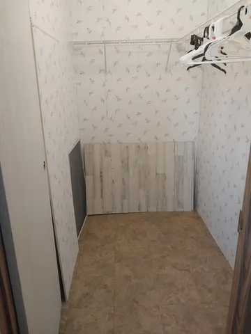 a en suite bathroom with a granite countertop sink and a toilet