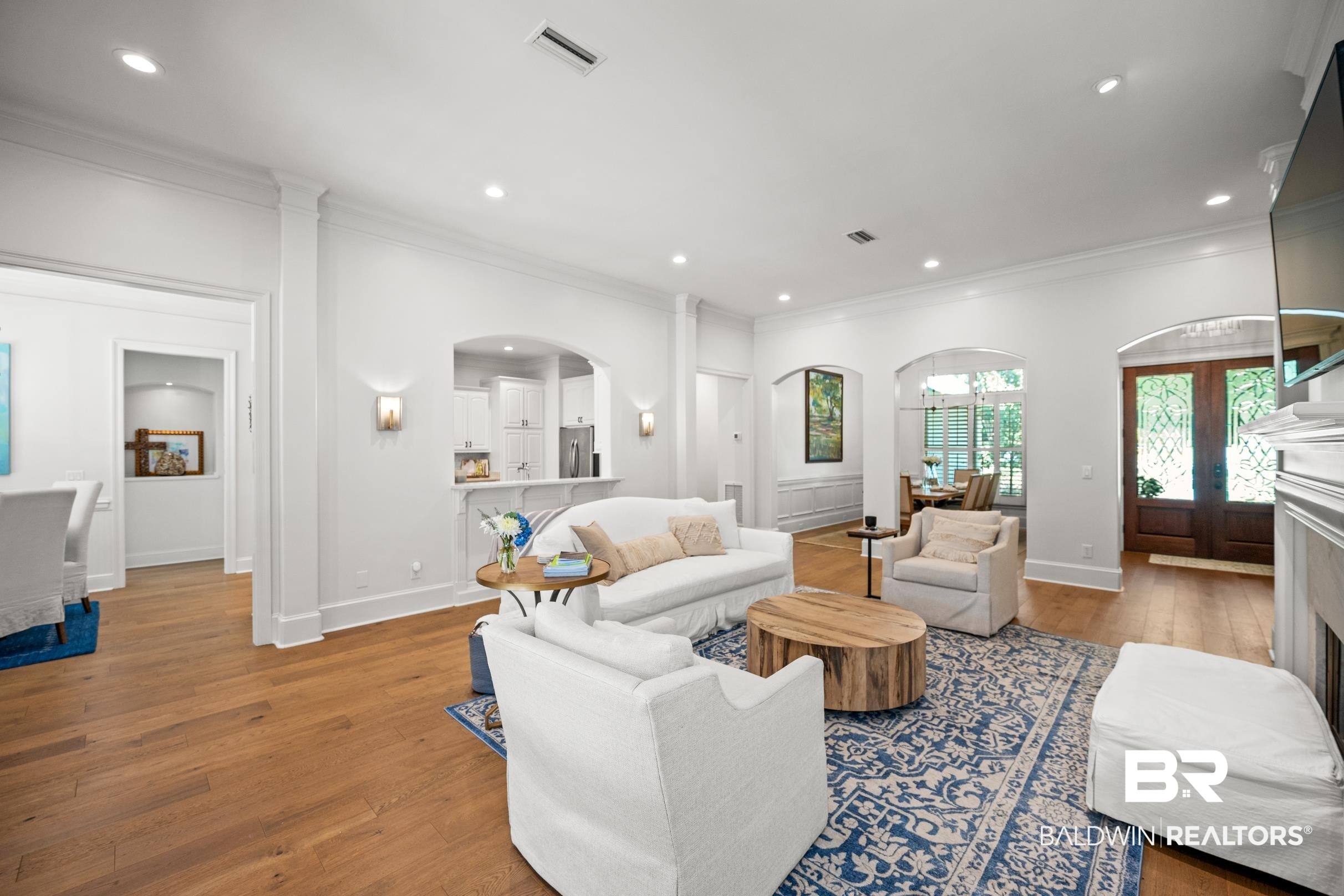 115 Sandy Ford Road Fairhope, AL 36532 - Photo 22 of 47 Living area featuring arched walkways, crown molding, wood finished floors, and recessed lighting