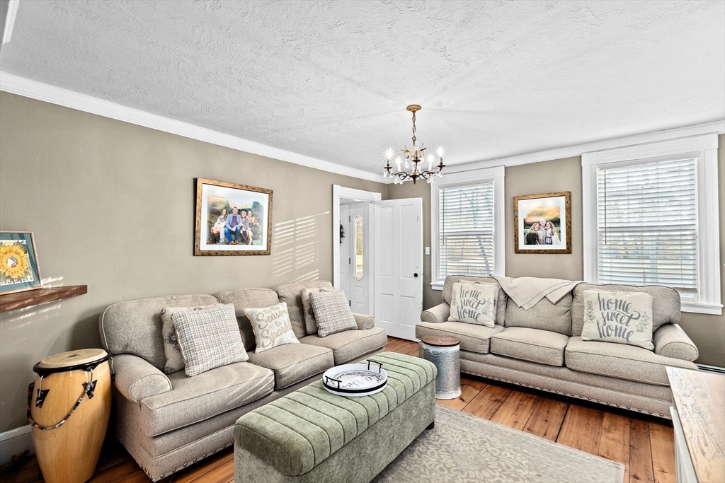85 Summit Street Halifax, MA 02338 - Photo 12 of 42 a living room with furniture a chandelier and a window