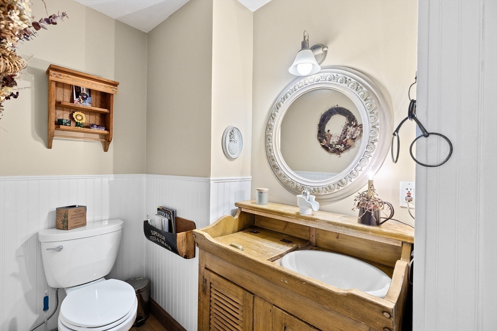 85 Summit Street Halifax, MA 02338 - Photo 18 of 42 a bathroom with a toilet mirror vanity and sink