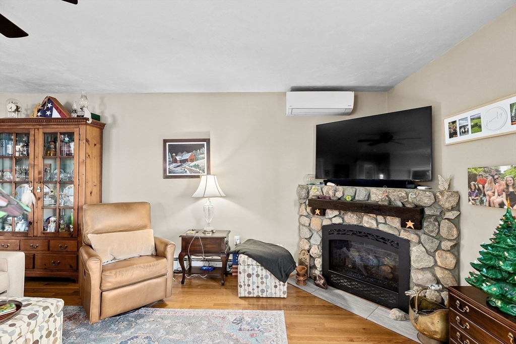 85 Summit Street Halifax, MA 02338 - Photo 28 of 42 a living room with furniture a flat screen tv and a fireplace
