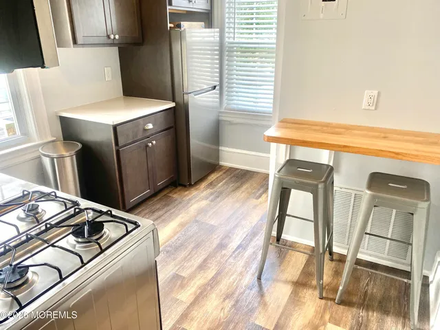 a kitchen with a stove top oven a sink and a window