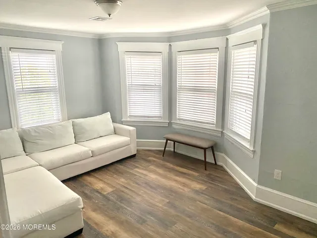 a living room with furniture and windows