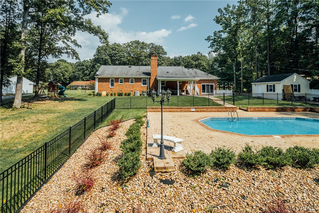 3918 Oxbridge Road North Chesterfield, VA 23236 - Photo 34 of 48 a view of a house with swimming pool and a yard