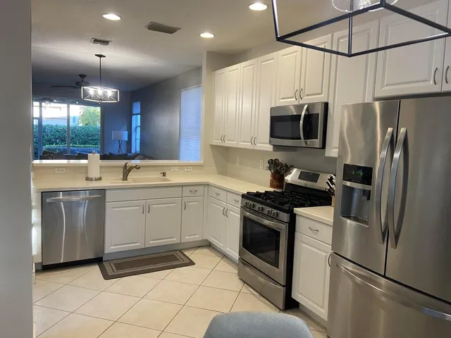 a kitchen with a sink cabinets and stainless steel appliances