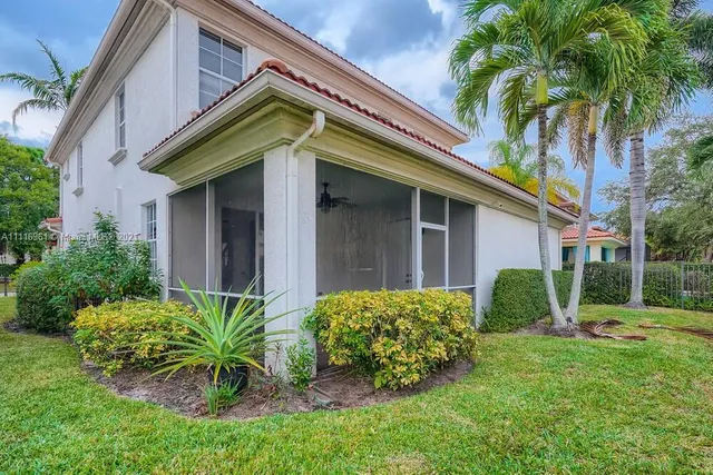 a view of a house with a yard and plants