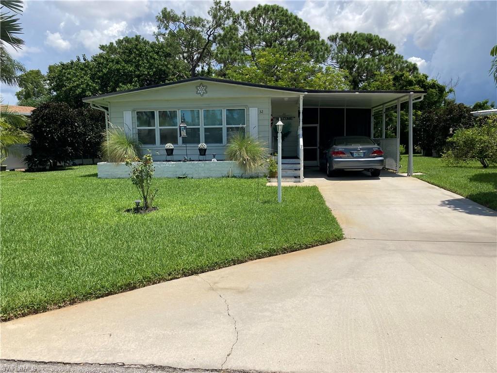 32 Lemans Drive Naples, FL 34112 - Photo 12 of 49 a front view of house with yard and green space