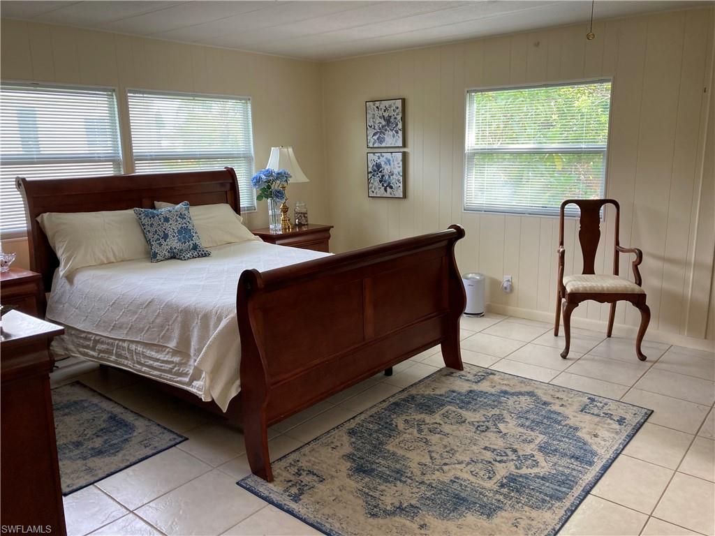 32 Lemans Drive Naples, FL 34112 - Photo 15 of 49 a living room with a bed furniture and next to a window