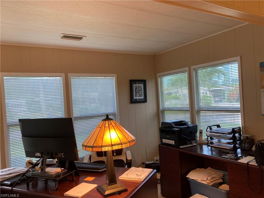 32 Lemans Drive Naples, FL 34112 - Photo 16 of 49 a room with furniture and a lamp