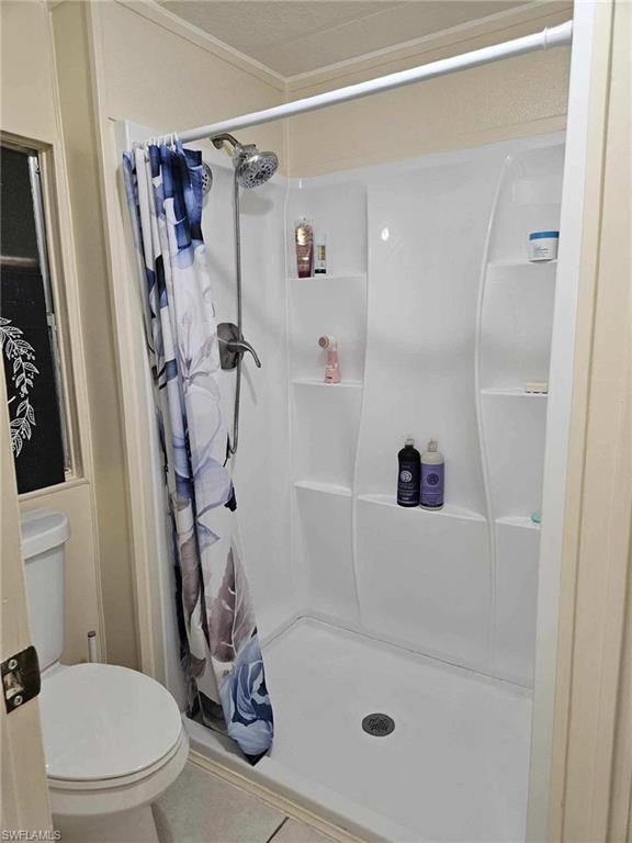32 Lemans Drive Naples, FL 34112 - Photo 17 of 49 a bathroom with a shower and a toilet