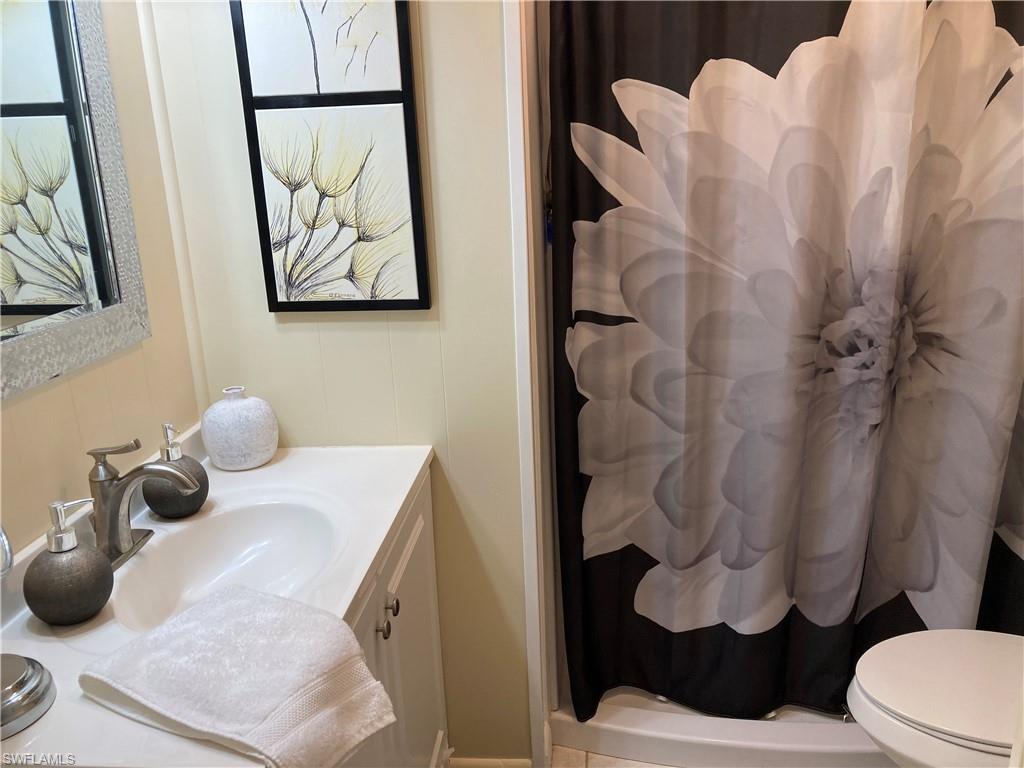 32 Lemans Drive Naples, FL 34112 - Photo 18 of 49 a bathroom with a sink toilet and mirror