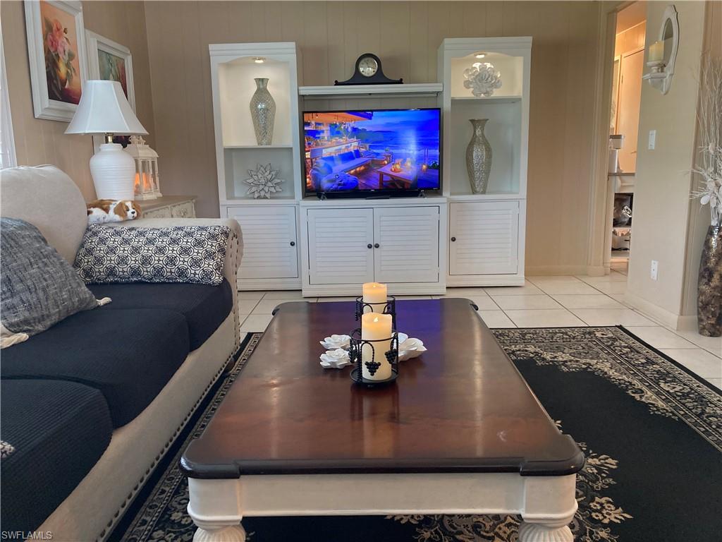 32 Lemans Drive Naples, FL 34112 - Photo 19 of 49 a living room with furniture and a flat screen tv
