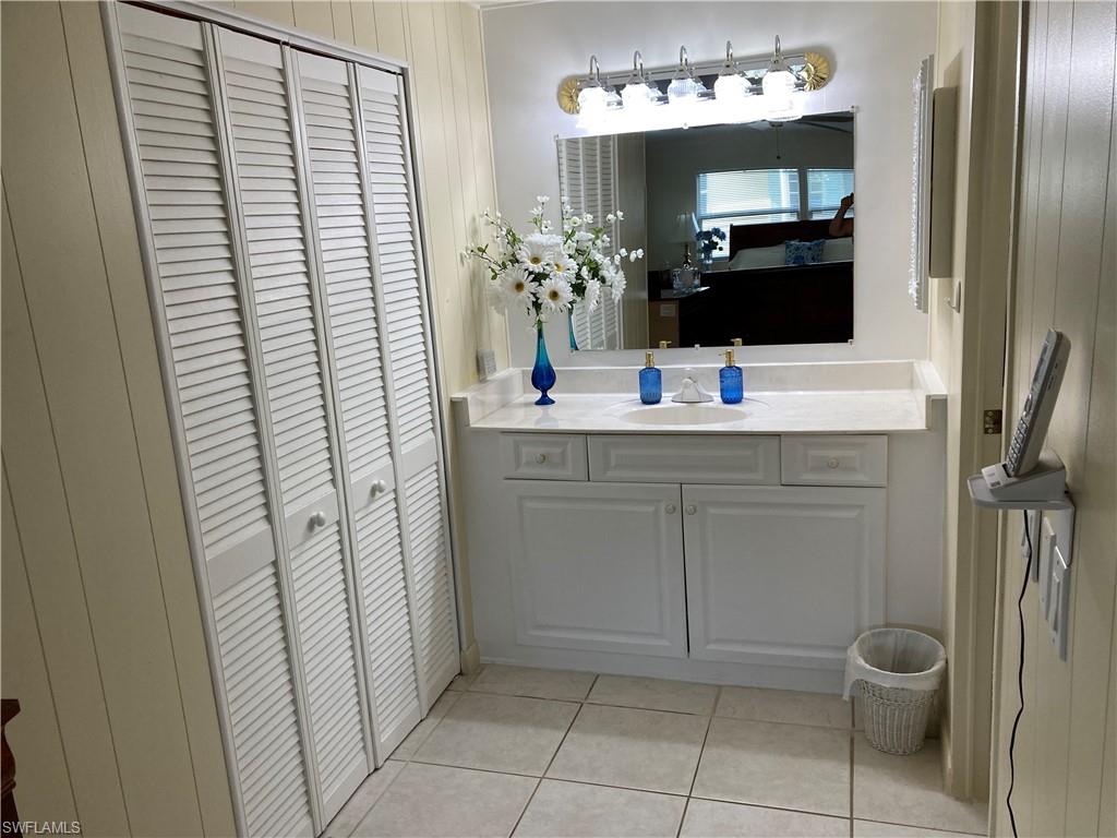 32 Lemans Drive Naples, FL 34112 - Photo 20 of 49 a bathroom with a sink a toilet and mirror