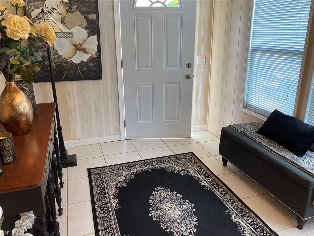 32 Lemans Drive Naples, FL 34112 - Photo 2 of 49 a room with a couch