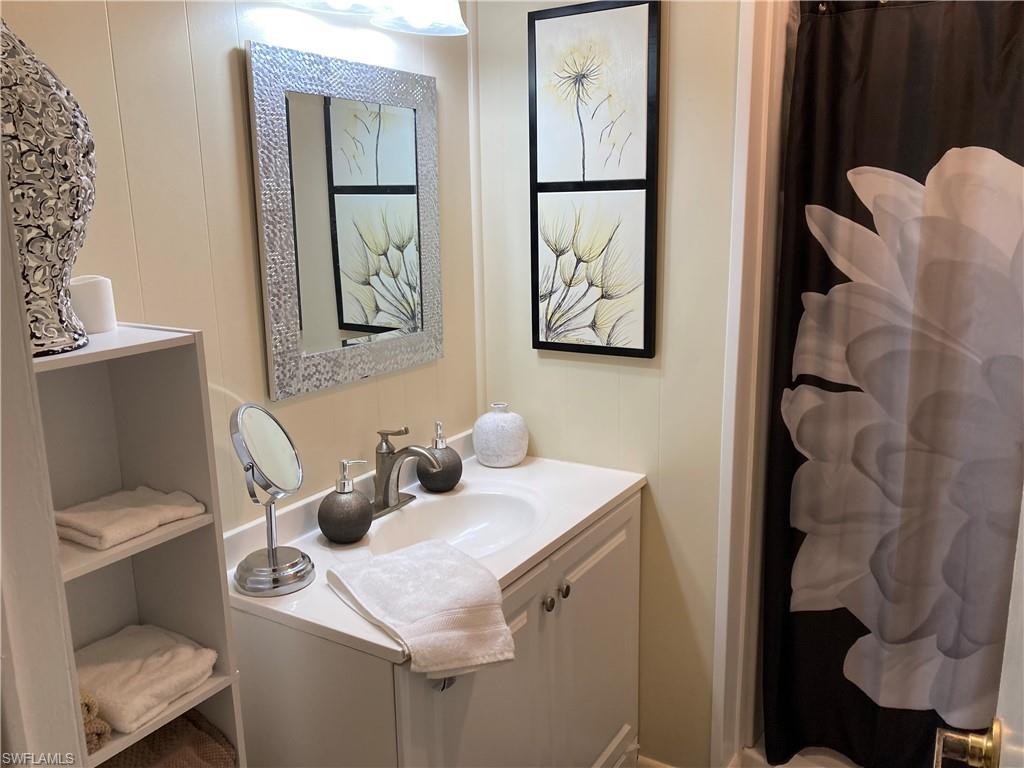 32 Lemans Drive Naples, FL 34112 - Photo 21 of 49 a bathroom with a toilet sink and mirror