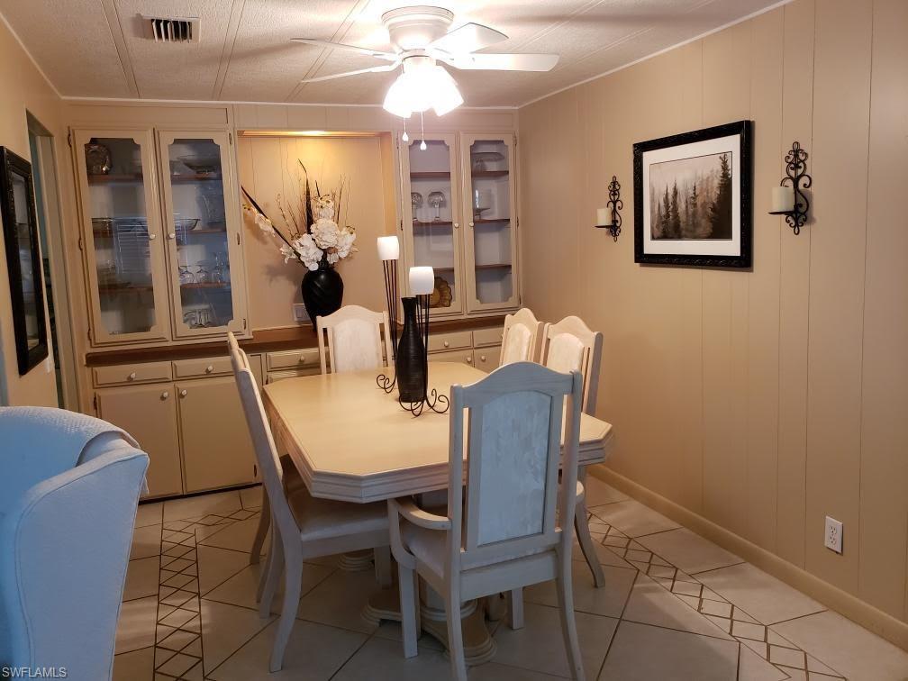 32 Lemans Drive Naples, FL 34112 - Photo 25 of 49 a view of a dining room with furniture and wooden floor