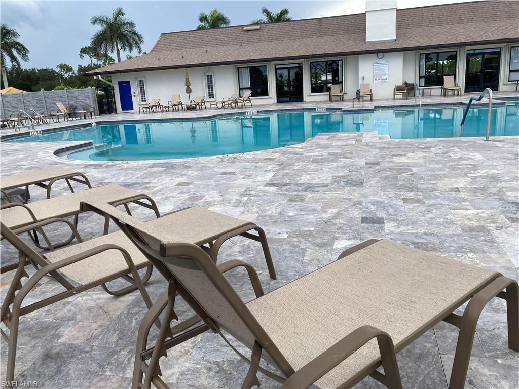 32 Lemans Drive Naples, FL 34112 - Photo 34 of 49 a view of a house with backyard and sitting area