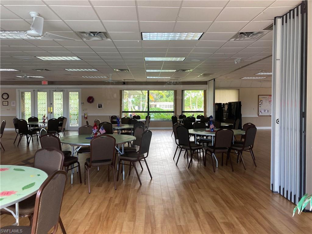 32 Lemans Drive Naples, FL 34112 - Photo 35 of 49 a view of a dining room with furniture window and wooden floor