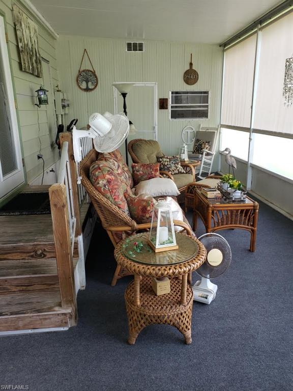 32 Lemans Drive Naples, FL 34112 - Photo 44 of 49 a living room with furniture and a window