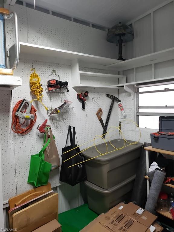 32 Lemans Drive Naples, FL 34112 - Photo 46 of 49 a room with gym equipment and wooden floor