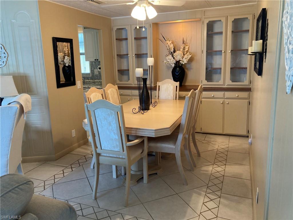 32 Lemans Drive Naples, FL 34112 - Photo 49 of 49 a view of a dining room with furniture and chandelier