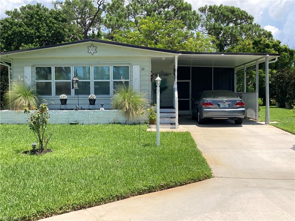 32 Lemans Drive Naples, FL 34112 - Photo 9 of 49 a house view with a garden space