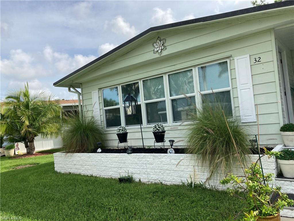 32 Lemans Drive Naples, FL 34112 - Photo 10 of 49 a front view of a house with a yard
