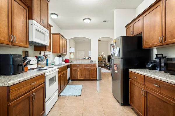 a kitchen with stainless steel appliances granite countertop a stove sink and cabinets