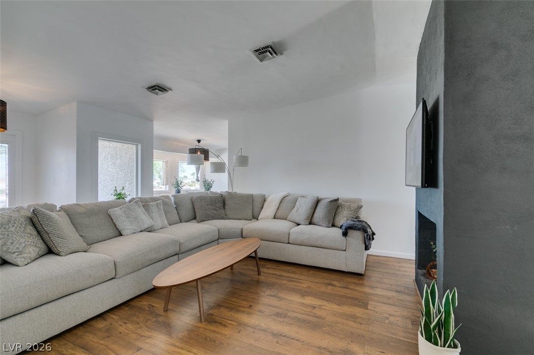 892 North Hollywood Boulevard Las Vegas, NV 89110 - Photo 18 of 81 Bright and open living space featuring warm wood flooring and a modern fireplace wall.