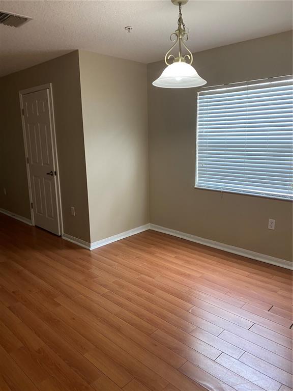118 Philadelphia Way Winter Springs, FL 32708 - Photo 4 of 20 a view of an empty room with wooden floor and a window