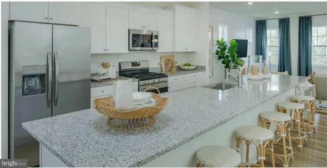 a kitchen with a table chairs and a refrigerator