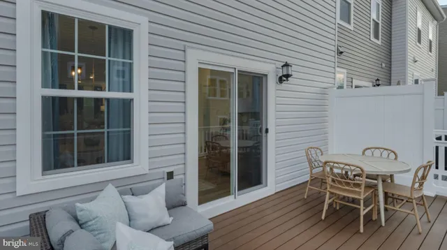a view of a chair and table in the back yard of the house