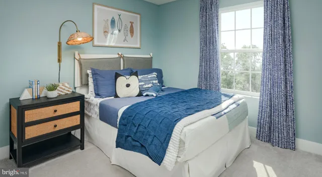 a bed sitting in a bedroom next to a window