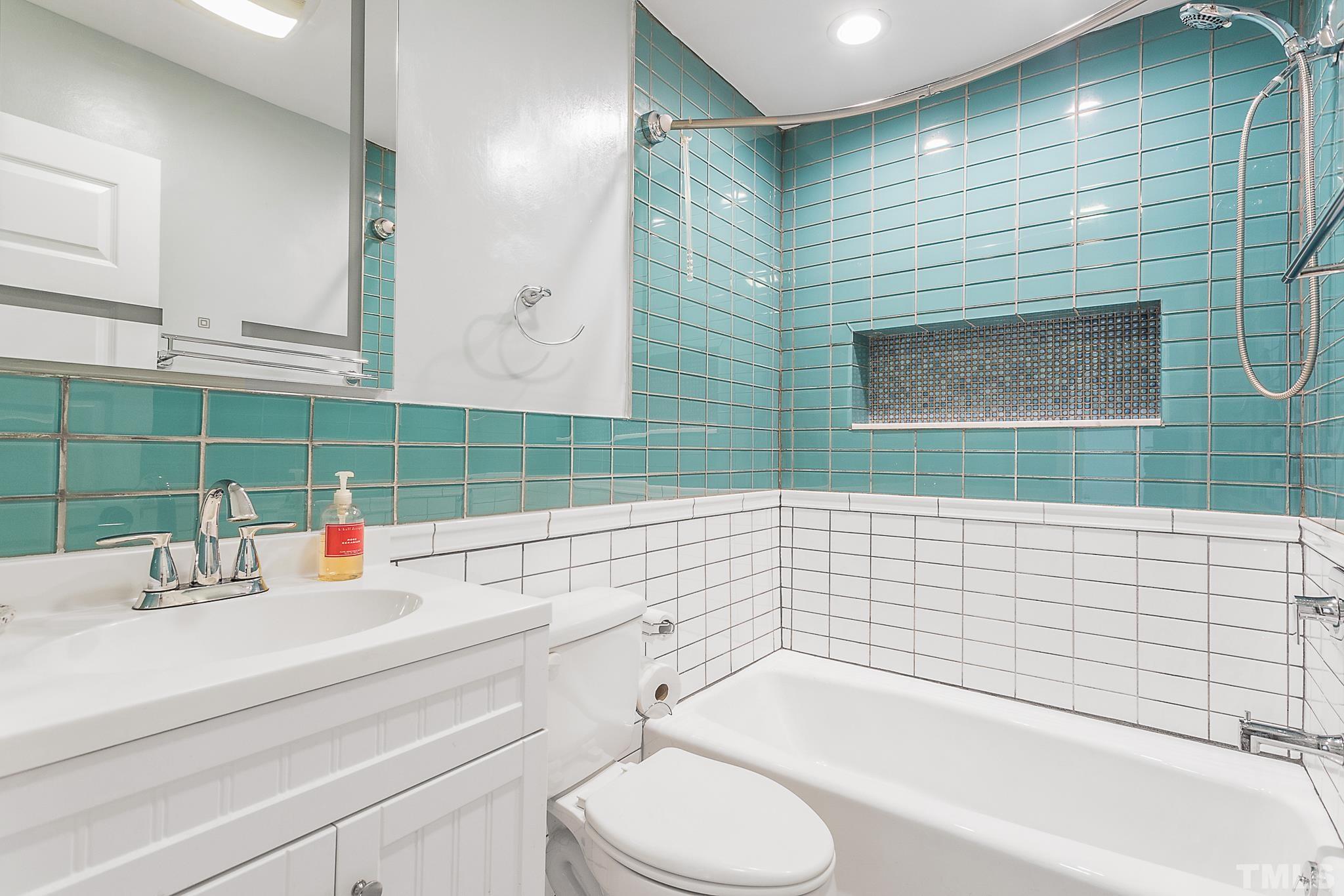 2222 Glascock Street Raleigh, NC 27610 - Photo 11 of 20 a bathroom with a sink a toilet and shower