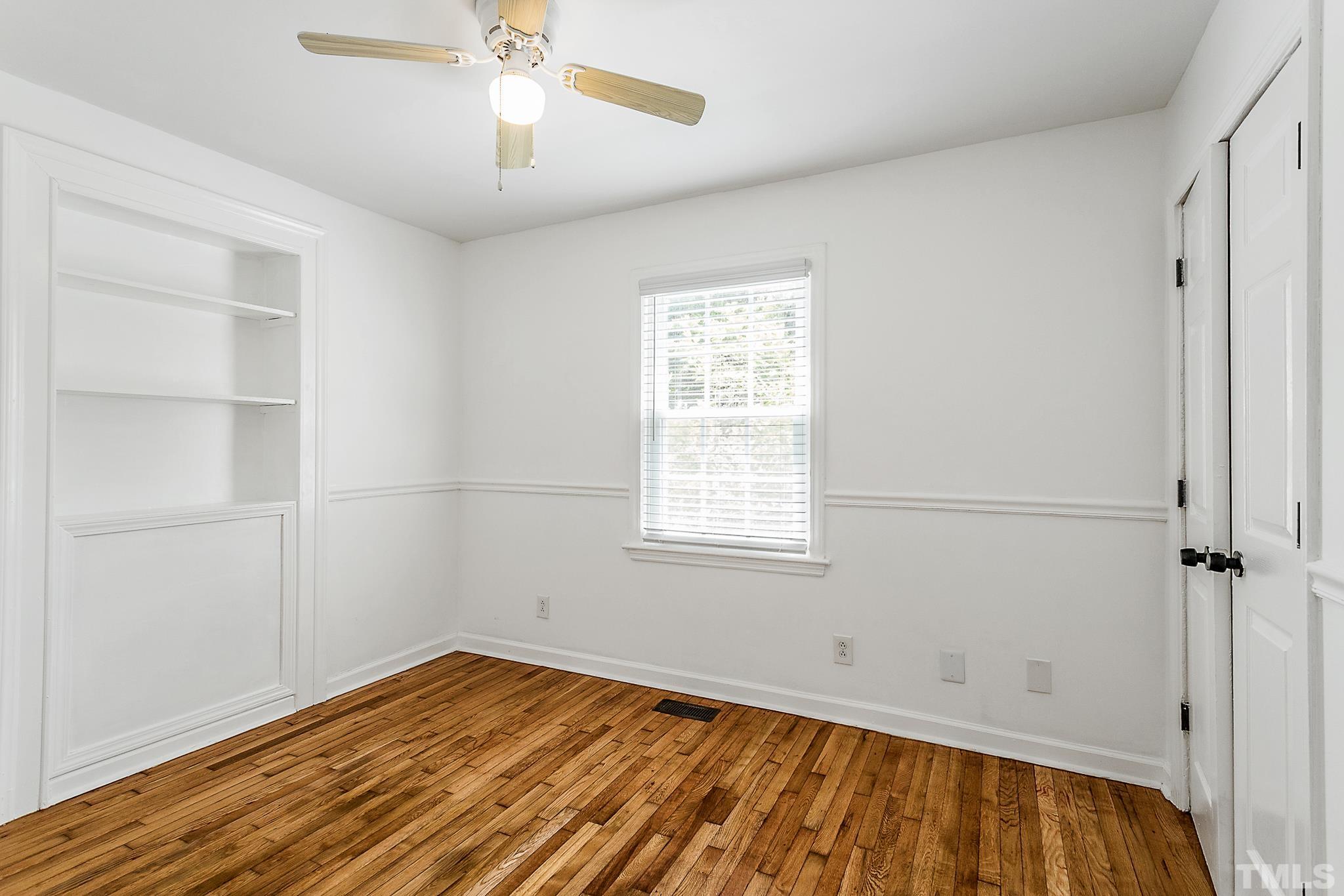 2222 Glascock Street Raleigh, NC 27610 - Photo 10 of 20 a view of empty room with wooden floor and fan