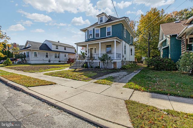 a view of a room with wooden floor and a window