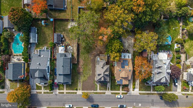 an aerial view of a residential apartment building with a yard and parking spaces