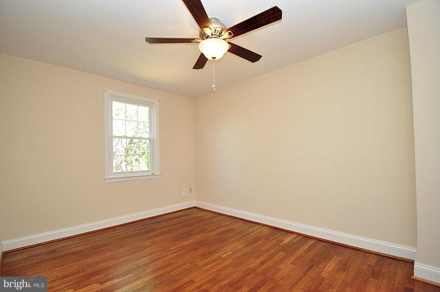 1841 Loch Shiel Road Baltimore, MD 21286 - Photo 13 of 23 an empty room with wooden floor fan and windows