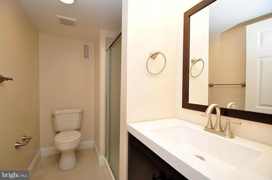 1841 Loch Shiel Road Baltimore, MD 21286 - Photo 17 of 23 a bathroom with a granite countertop sink toilet a mirror and a tub