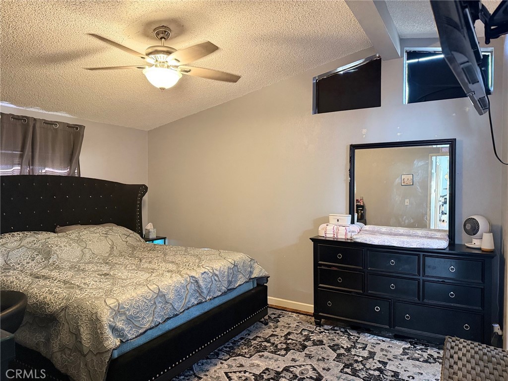 4080 Pedley Road, Unit 211 Jurupa Valley, CA 92509 - Photo 11 of 13 a bedroom with a bed and a mirror on the dresser