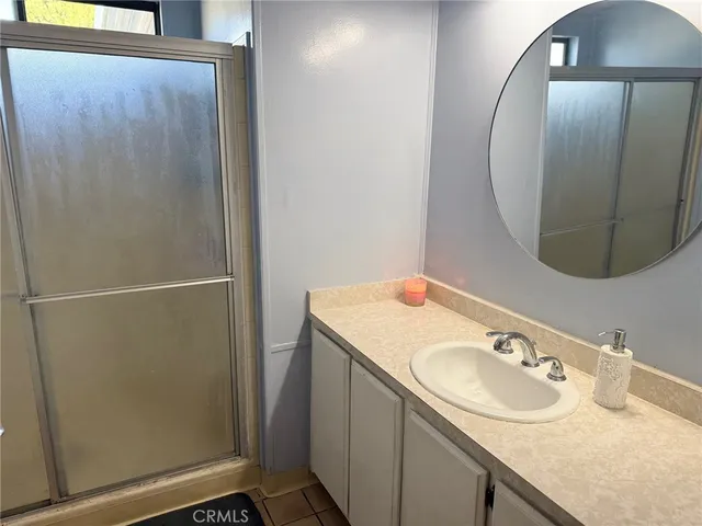 a bathroom with a sink vanity and a mirror