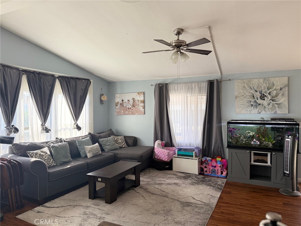 4080 Pedley Road, Unit 211 Jurupa Valley, CA 92509 - Photo 2 of 13 a living room with furniture a window and a flat screen tv