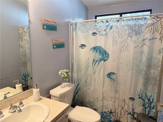 a white toilet sitting next to a bathroom sink