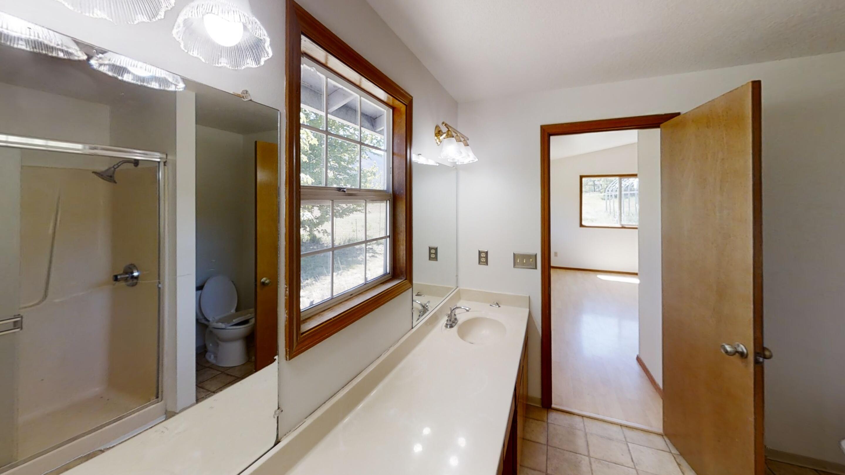 4748 Upper Applegate Road Jacksonville, OR 97530 - Photo 21 of 31 a bathroom with a glass shower door and a sink