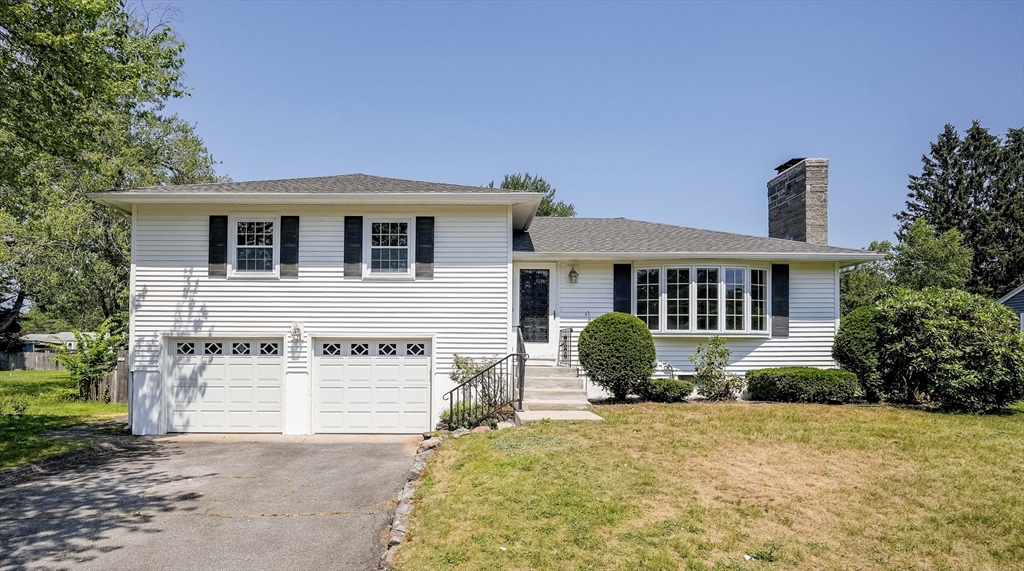 76 Clydesdale Lane Springfield, MA 01129 - Photo 1 of 39 a front view of a house with a yard and garage