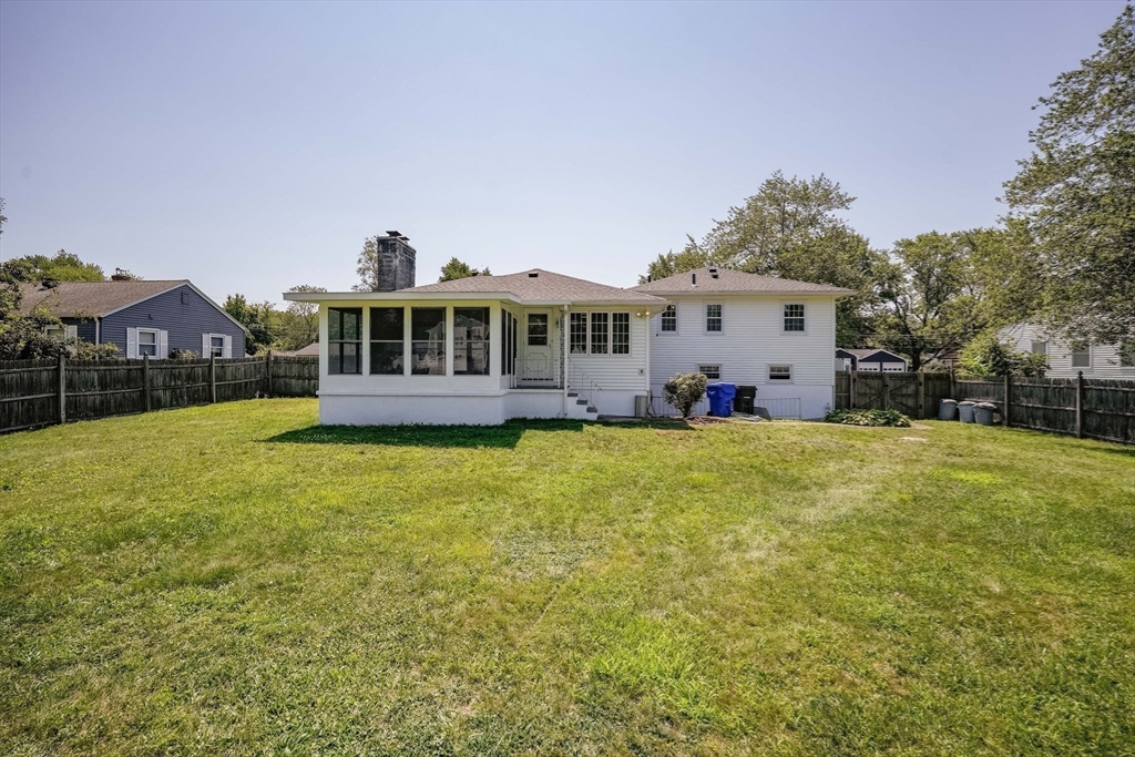 76 Clydesdale Lane Springfield, MA 01129 - Photo 29 of 39 a front view of a house with a yard table and chairs