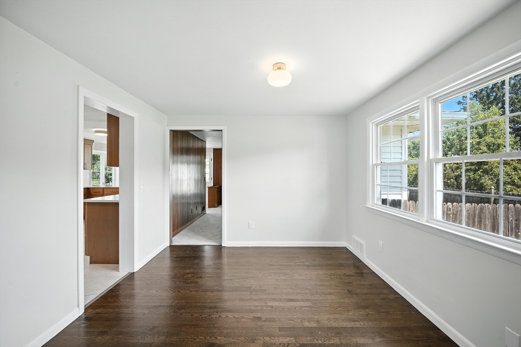 76 Clydesdale Lane Springfield, MA 01129 - Photo 5 of 39 a view of an empty room with wooden floor and a window