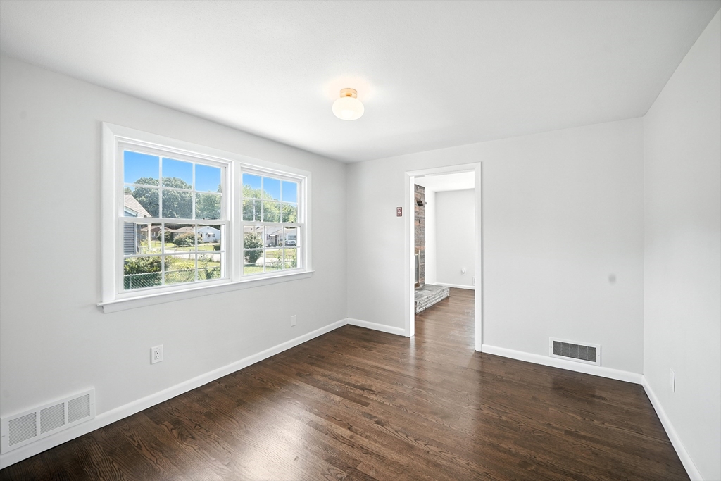 76 Clydesdale Lane Springfield, MA 01129 - Photo 6 of 39 an empty room with wooden floor and windows