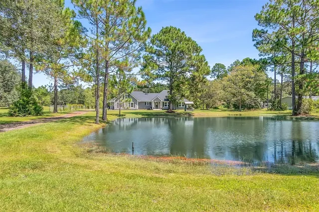 a front view of house with yard and green space